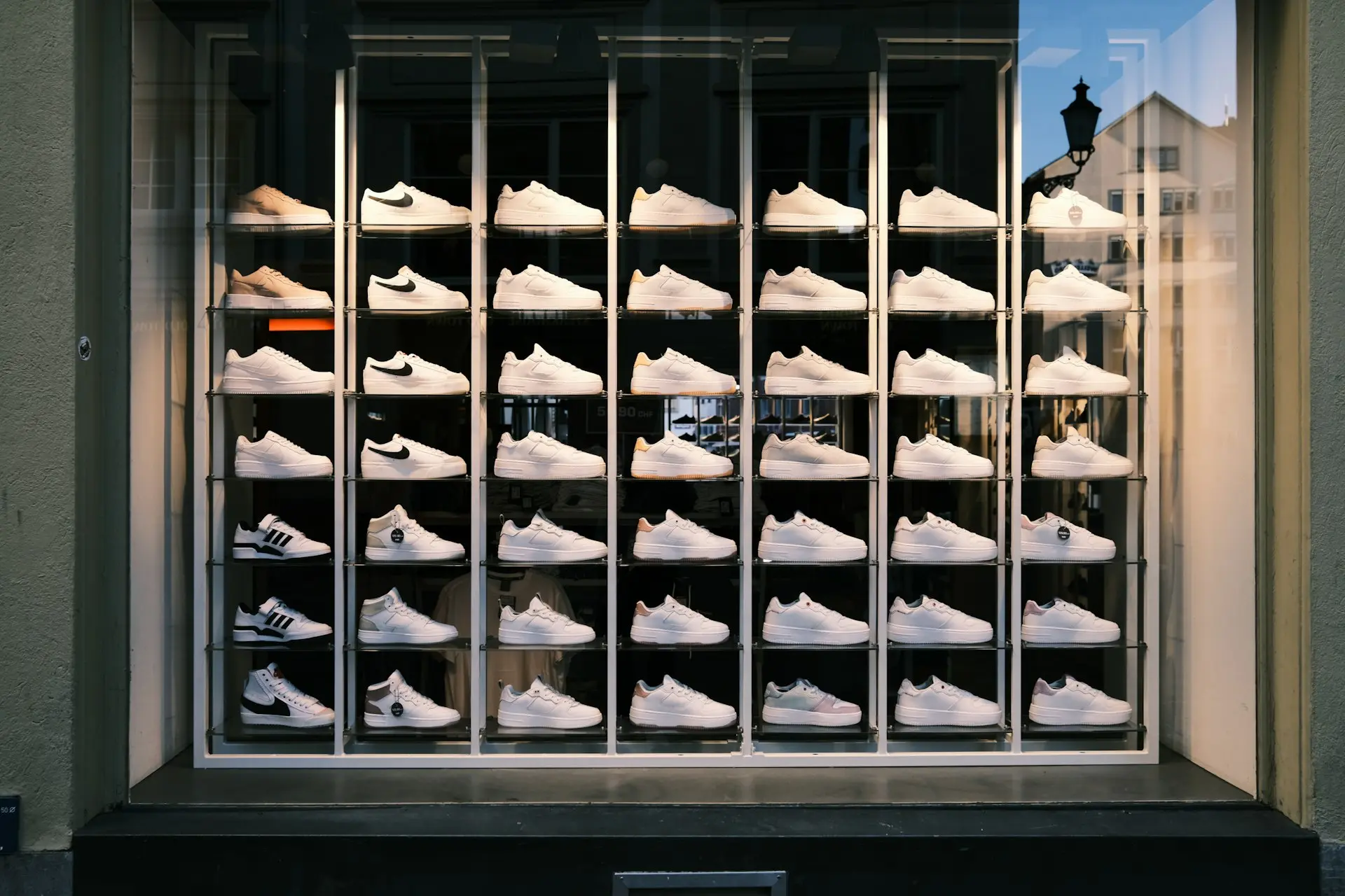 a display of white shoes in a window